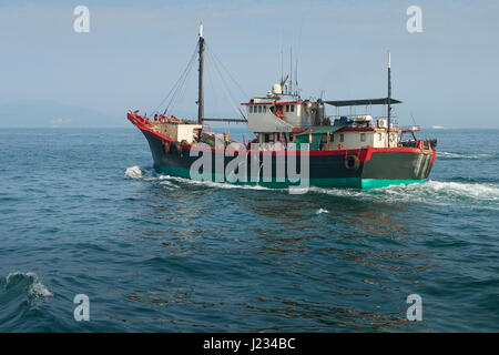 Fishing Boat Leaving Aberdeen Channel, Hong Kong. Stock Photo