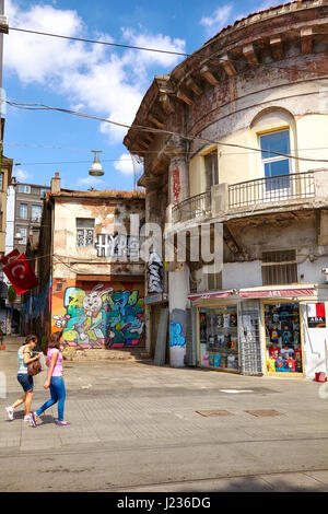 ISTANBUL, TURKEY - JULY 13, 2014: Old buildings with modern graffiti pictures on Istiklal Avenue ( Istiklal Caddesi or Independence Avenue is one of t Stock Photo