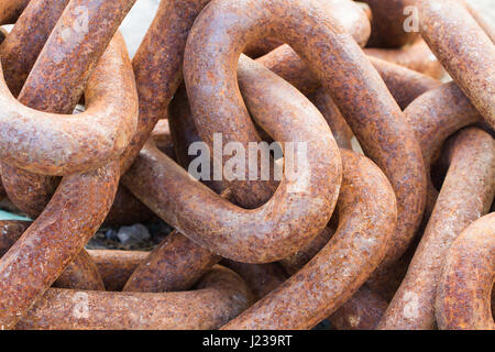 A close up image of thick, heavy metal chains tangled up together and filling the frame in an industrial, background image. Stock Photo
