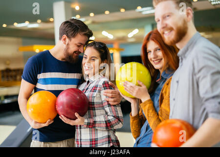 Friends having great time playing bowling and laughing Stock Photo