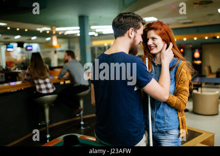 Couple hugging in snooker bar  on their date Stock Photo