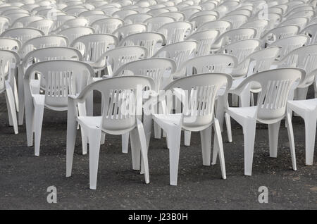 Rows of empty white chairs waiting for the audience Stock Photo