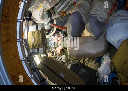 NASA Expedition 50 prime crew member Russian cosmonaut Andrei Borisenko of Roscosmos gathers equipment inside the Russian segment of the International Space Station December 29, 2016 in Earth orbit.    (photo by NASA via Planetpix) Stock Photo