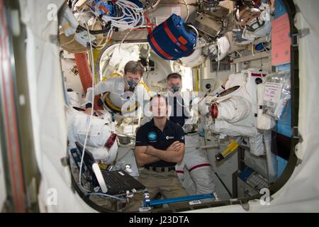 NASA Expedition 50 prime crew (L-R) American astronaut Peggy Whitson, French astronaut Thomas Pesquet of the European Space Agency, and American astronaut Shane Kimbrough breathe pure oxygen inside the Quest airlock aboard the International Space Station prior to a spacewalk January 6, 2017 in Earth orbit.    (photo by NASA via Planetpix) Stock Photo