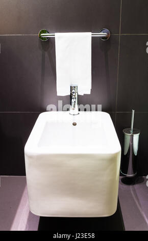 Square modern bidet in a black tiled modern bathroom Stock Photo