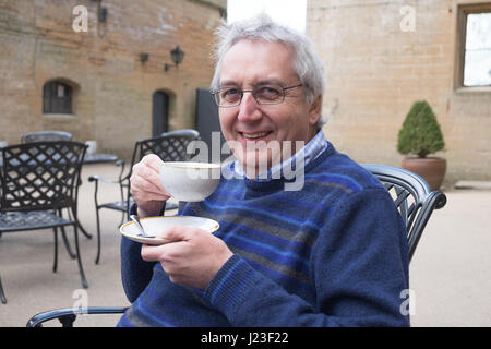 Senior man, drinking tea in outdoor cafe Stock Photo