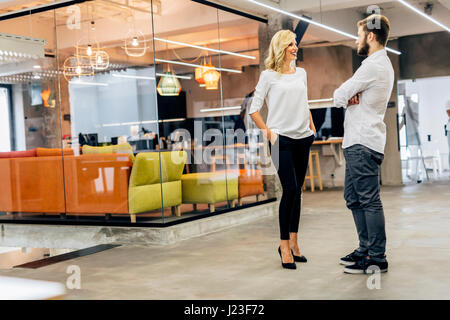 Office talk between colleagues at work Stock Photo