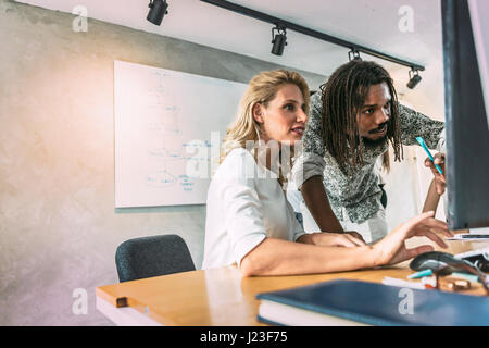 Designers working on a project and discussing new ideas Stock Photo