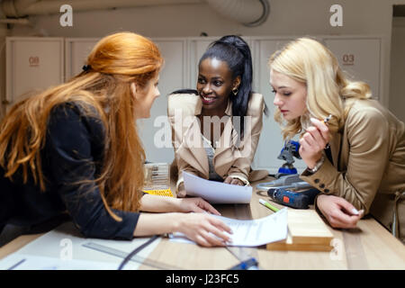 Creative workers designing and planing together in workshop Stock Photo