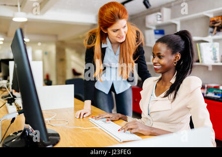 Businesswoman supervising employee in modern office Stock Photo
