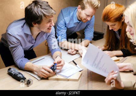 Creative workers designing and planing together in workshop Stock Photo