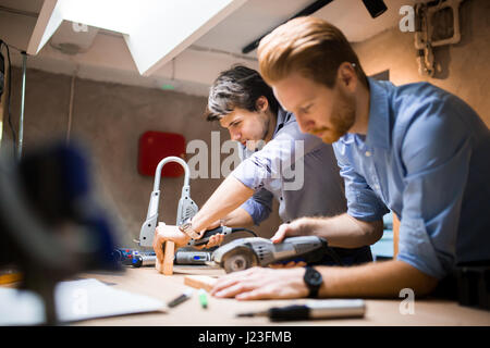 Two designers working on a project in workshop with joint effort Stock Photo