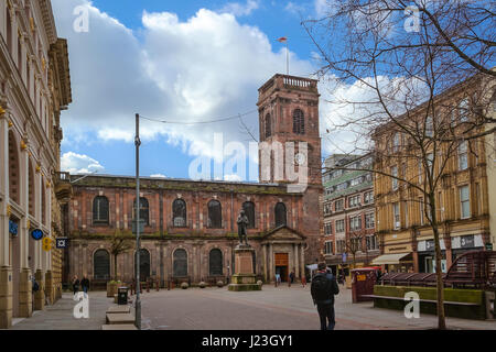 Exterior view of the Saint Annes Church in Manchester, UK. View of the St. Annes square and the statute