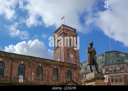Exterior view of the Saint Ann's Church in Manchester, UK. View of the St. Ann's square and the statute