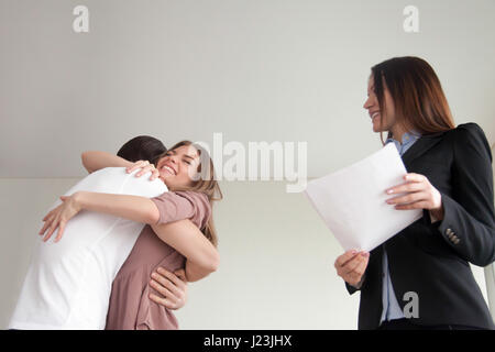 Happy young family couple embracing, just bought new apartment h Stock Photo