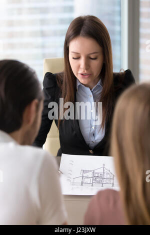 Presenting house plan, building project on meeting with clients  Stock Photo