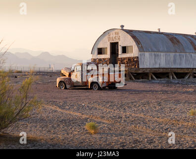 A rusty, abandoned pickup truck car wreck stands left behind in the desert near Tecopa Hot Springs, CA, on 8 August 2016. Stock Photo