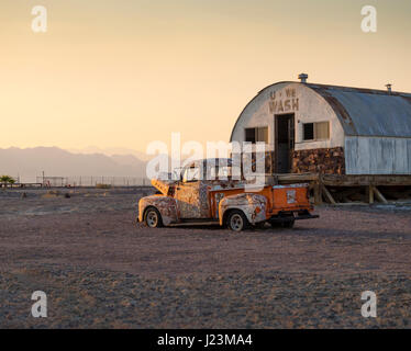 A rusty, abandoned pickup truck car wreck stands left behind in the desert near Tecopa Hot Springs, CA, on 8 August 2016. Stock Photo