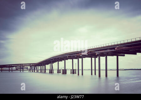 Disused Oil Jetty Across Holehaven Creek Formerly Used to connect Unloading Berths to Storage on Canvey Island Stock Photo