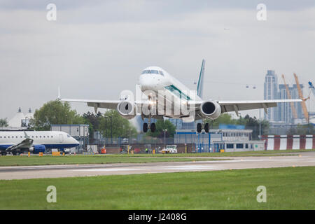 Commercial jet airliner airplane landing on the runway of a busy modern airport Stock Photo