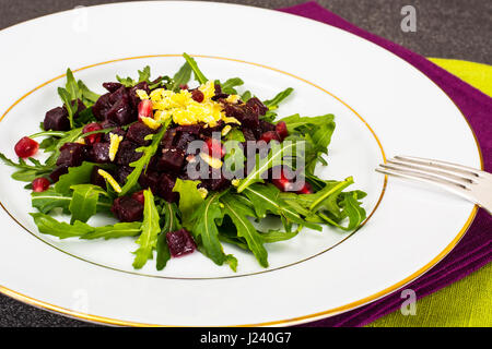 Vegetarian salad with arugula, beetroot and pomegranate. Studio Photo Stock Photo