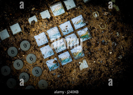 An electronic keyboard buried in dirt, signifying a post apocalytic world Stock Photo