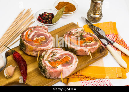 Raw meat rolls on wooden skewers for frying. Studio Photo Stock Photo