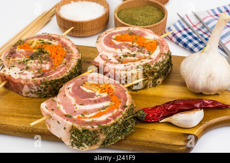 Raw meat rolls on wooden skewers for frying. Studio Photo Stock Photo