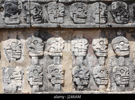 Bas-relief carving with human skulls on Tzompantli (Wall of Skulls), Skull Rack Temple, pre-Columbian Maya civilization, Chichen Itza, Yucatan, Mexico Stock Photo