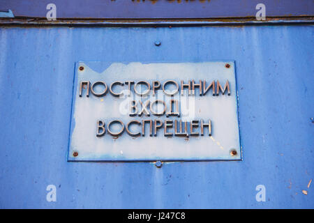 A sign on the blue door, no trespassing.In the Russian language. Retro Stock Photo