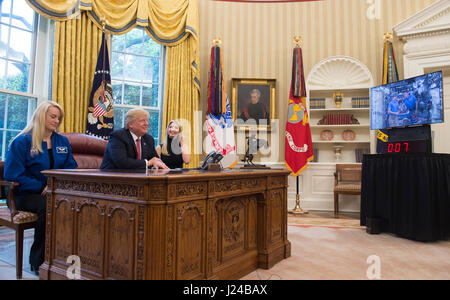 Washington, Us. 24th Apr, 2017. United States President Donald Trump speaks along with his daughter Ivanka and NASA Astronaut Kate Rubins, during a video conference with NASA astronauts aboard the International Space Station in the Oval Office at the White House on April 24, 2017. Credit: Molly Riley/Pool via CNP - NO WIRE SERVICE - Photo: Molly Riley/Consolidated News Photos/Molly Riley - Pool via CNP/dpa/Alamy Live News Stock Photo