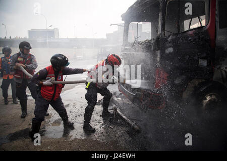 Caracas, Venezuela. 24th Apr, 2017. Firemen extinguish flames during a protest in Caracas, Venezuela, on April 24, 2017. Venezuelan Foreign Minister Delcy Rodriguez on Saturday called for 'true and accessible' global media coverage of the recent situation in the country. Since April 1, Venezuela has seen intense protests by both government and opposition supporters in Caracas and across the country, which have claimed at least 15 lives. Credit: Boris Vergara/Xinhua/Alamy Live News Stock Photo