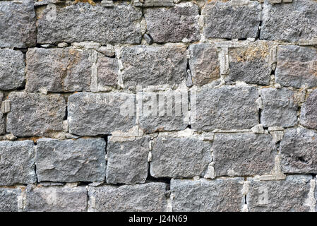 Background from an rough grey natural stone wall Stock Photo