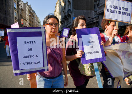 Thousands of women wave banners as they protest violence against women on International Day for the Elimination of Violence against Women in Buenos Aires on November 25, 2016. Stock Photo