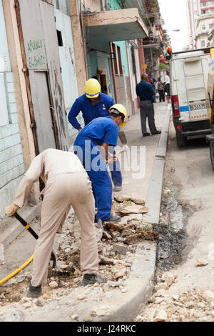 Workers demolishing a sidewalk in Havana, Cuba. Stock Photo