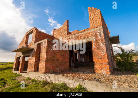 Exterior of an old building under construction. Orange brick walls in a new house. Stock Photo