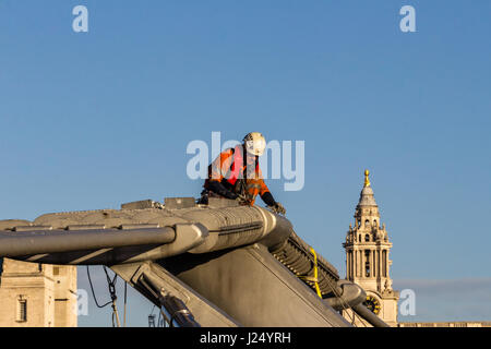 Bridge Engineer, wearing a safety harness, inspecting the Millennium Bridge, London Stock Photo