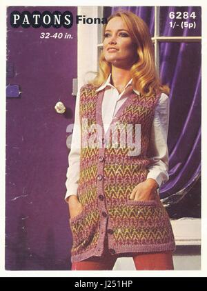Original example of Patons retro knitting pattern from the late 1970's, the model is wearing a long hand knitted Fairisle style button down cardigan, U.K. circa 1979 Stock Photo
