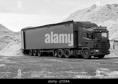 Riga, Latvia - September 25, 2016: The Port of Riga. Truck warehouse place landed in sawdust loads. Stock Photo