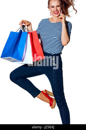 Shopping. The French way. cheerful stylish fashion-monger with shopping bags of the colours of the French flag isolated on white posing Stock Photo