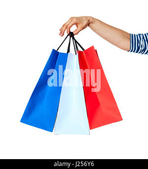 Shopping. The French way. Closeup on hands with shopping bags of the colours of the French flag isolated on white background Stock Photo
