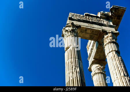 Low angle view of three columns from Apollo Sosiano's Temple, Sunny, blue sky. Rome, Italy, Europe. Classical corinthian style.Copy space, close up. Stock Photo