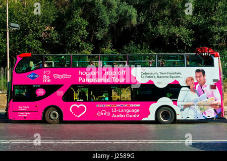 Pink sightseeing double decker open bus, tourism. Hop on hop off. Rome, Italy, Europe, European Union, EU. Stock Photo