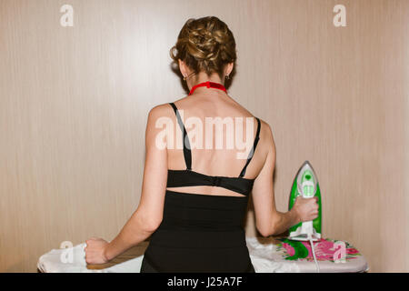 Woman standing and ironing Stock Photo