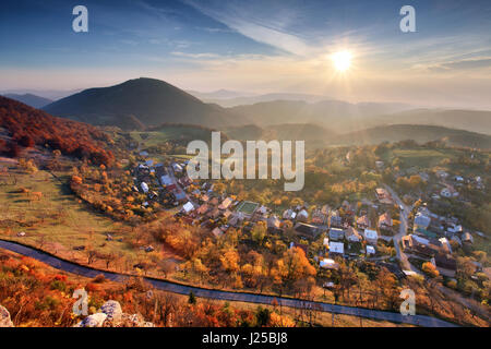 Village at autumn with sun Stock Photo