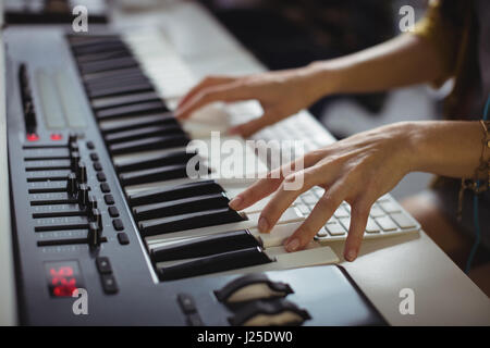 Mid-section of female sound engineer working in office Stock Photo