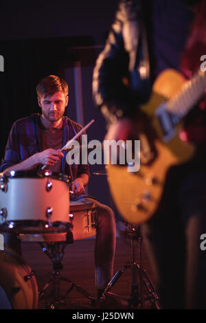 Drummer playing drums in recording studio Stock Photo