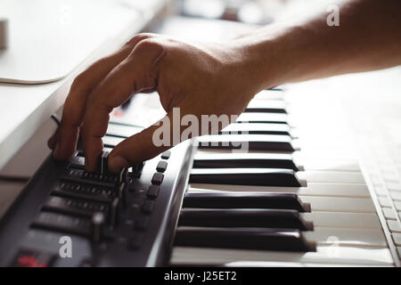 Hand of male audio engineer using sound mixer in recording studio Stock Photo