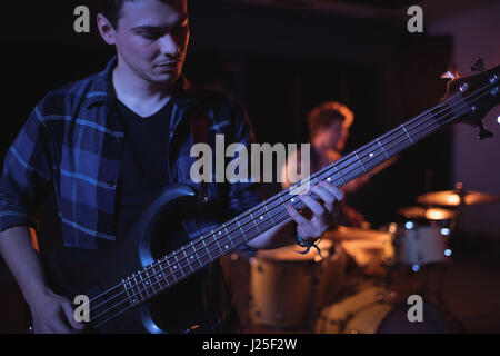 Guitarist playing electric guitar in recording studio Stock Photo