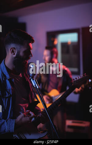 Singer singing in recording studio Stock Photo